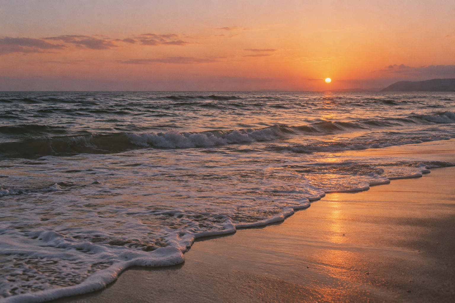 Gentle ocean waves beneath a warm sunset
